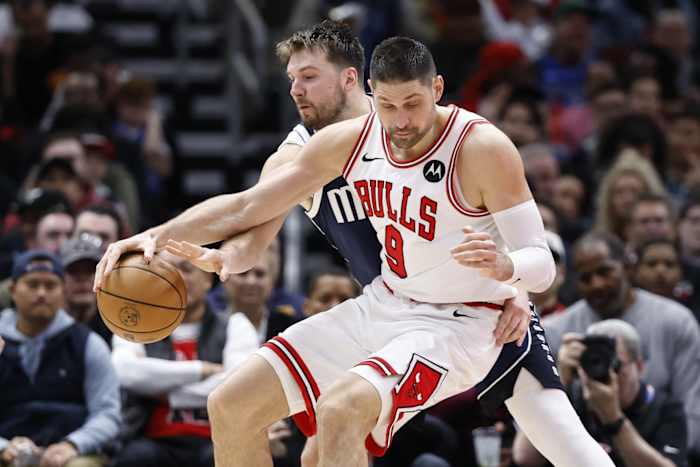 Dallas Mavericks guard Luka Doncic (77) defends against Chicago Bulls center Nikola Vucevic (9) during the second half at United Center.